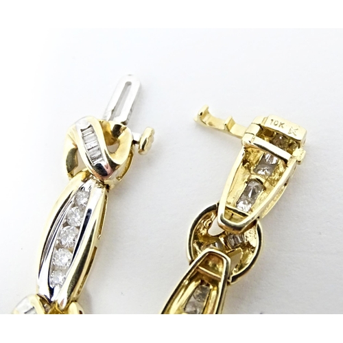 634 - A 9ct gold bracelet set with 50 diamonds interspersed by further bands of diamonds. Marked 10k. Appr... 