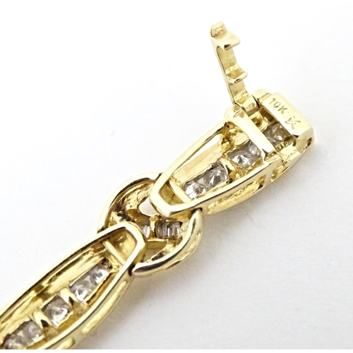 634 - A 9ct gold bracelet set with 50 diamonds interspersed by further bands of diamonds. Marked 10k. Appr... 