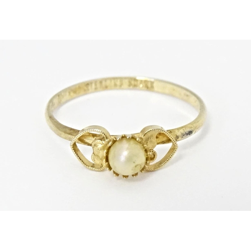 568A - A silver gilt ring set with central pearl. Marked Sterling Shank. Ring size approx. I