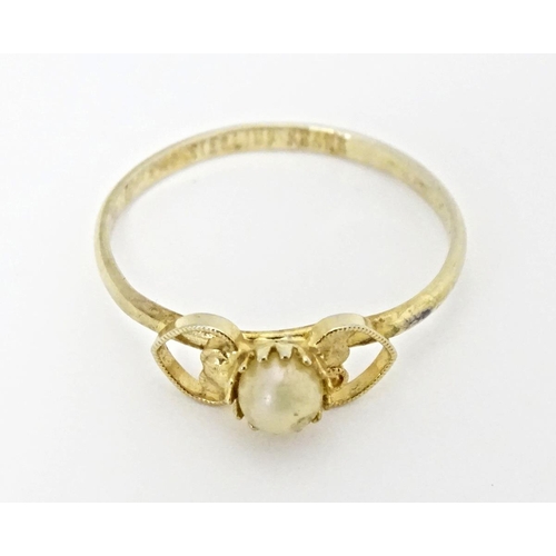 568A - A silver gilt ring set with central pearl. Marked Sterling Shank. Ring size approx. I