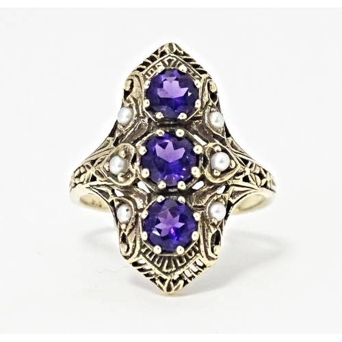 569 - A 9ct gold ring set with amethysts and seed pearls. Ring size approx. O