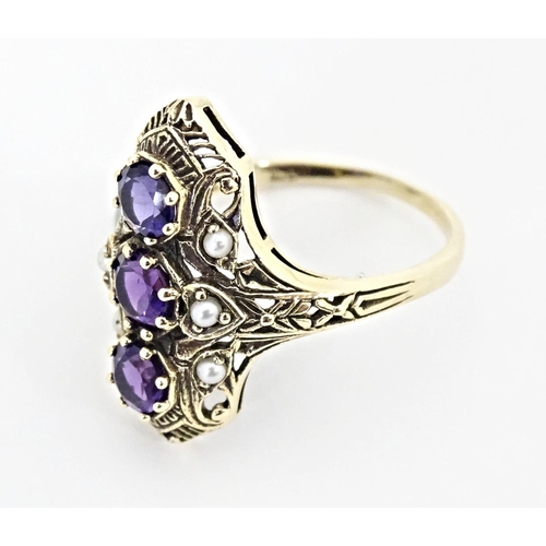 569 - A 9ct gold ring set with amethysts and seed pearls. Ring size approx. O