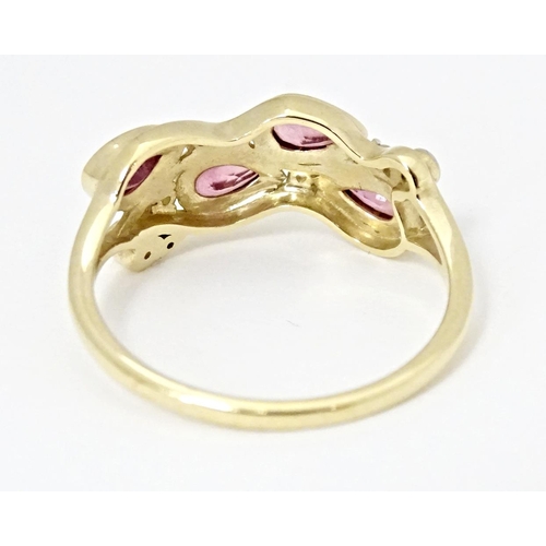 571 - A 9ct gold ring set with Padparadscha sapphire and white zircons. Ring size approx. R