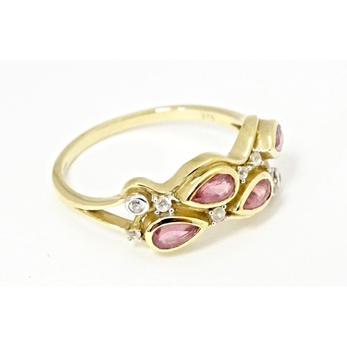 571 - A 9ct gold ring set with Padparadscha sapphire and white zircons. Ring size approx. R