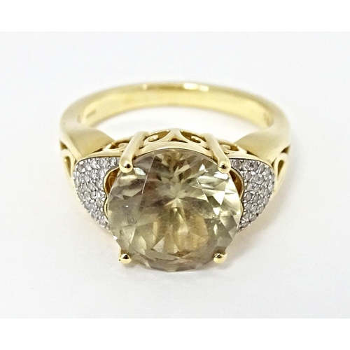 586 - An 18ct gold ring set with central Csarite flanked by diamonds. Ring size approx. N