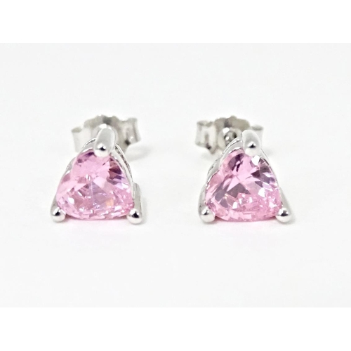 642 - A pair of silver stud earrings set with pink stones of heart.