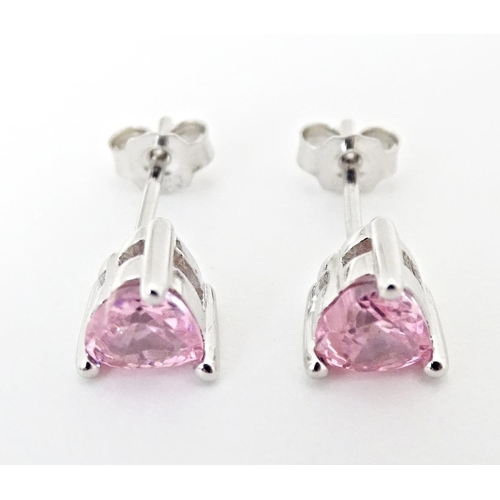 642 - A pair of silver stud earrings set with pink stones of heart.