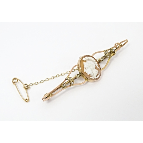 644 - A 9ct gold bar brooch set with central shell carved cameo and seed pearl detail. Together with a Vic... 