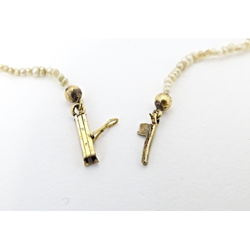 648 - A graduated pearl necklace with yellow metal clasp. Approx. 13 1/2