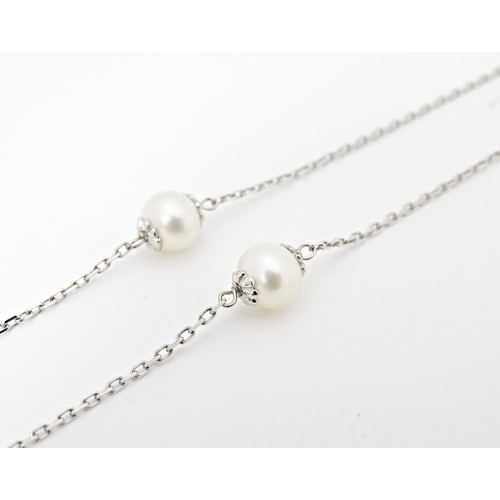 652 - An 18ct white gold necklace set with pearl beads. Approx. 36