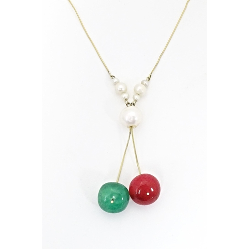 653 - A 14ct gold necklace set with pearl, green and red stone beads. Approx. 17