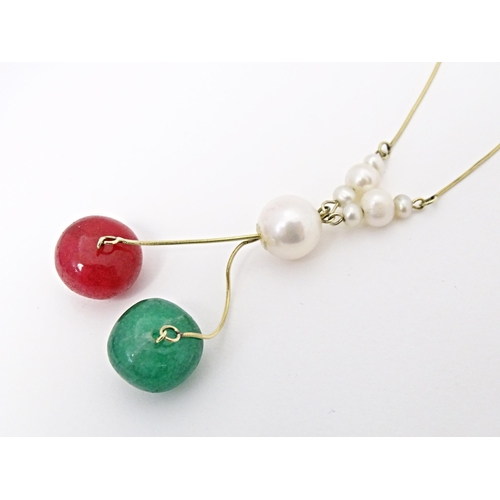 653 - A 14ct gold necklace set with pearl, green and red stone beads. Approx. 17