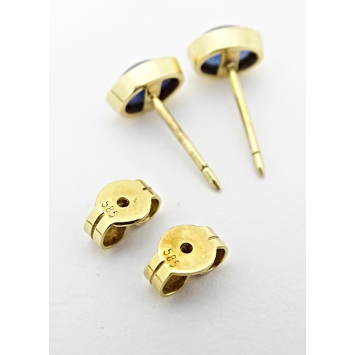 651 - A pair of 14ct gold stud earrings set with sapphire cabochon. Approx. 1/4