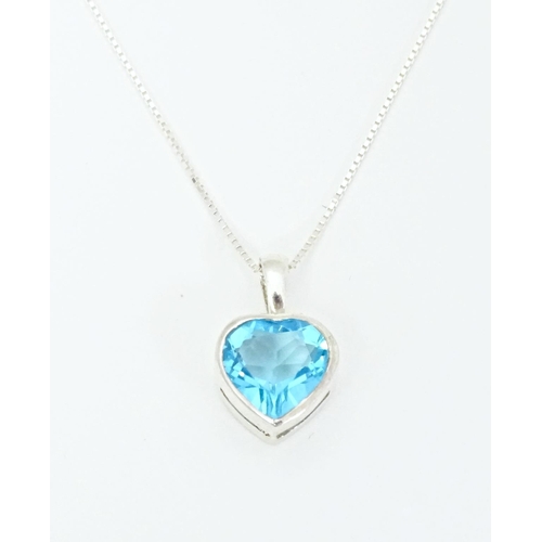 656 - A silver pendant and chain, the heart shaped pendant set with blue coloured detail. Pendant approx. ... 