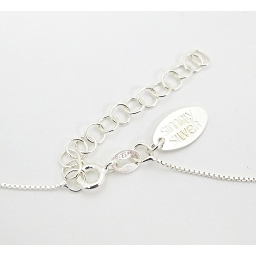 656 - A silver pendant and chain, the heart shaped pendant set with blue coloured detail. Pendant approx. ... 