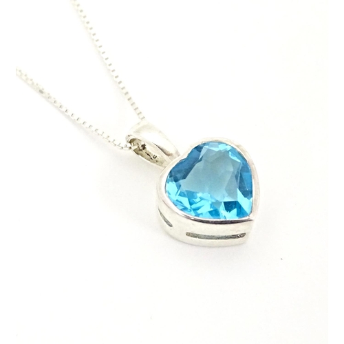 656 - A silver pendant and chain, the heart shaped pendant set with blue coloured detail. Pendant approx. ... 