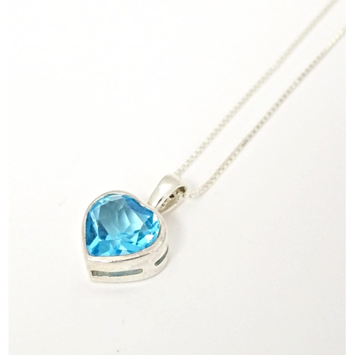 656 - A silver pendant and chain, the heart shaped pendant set with blue coloured detail. Pendant approx. ... 