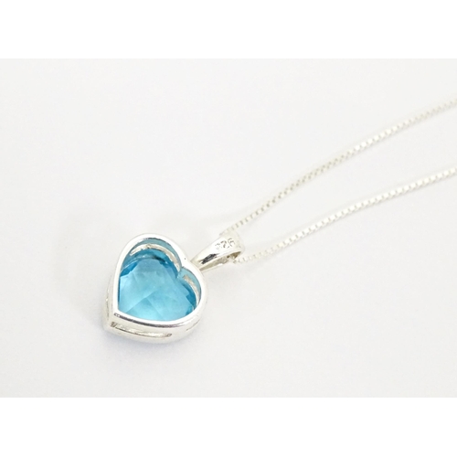 656 - A silver pendant and chain, the heart shaped pendant set with blue coloured detail. Pendant approx. ... 