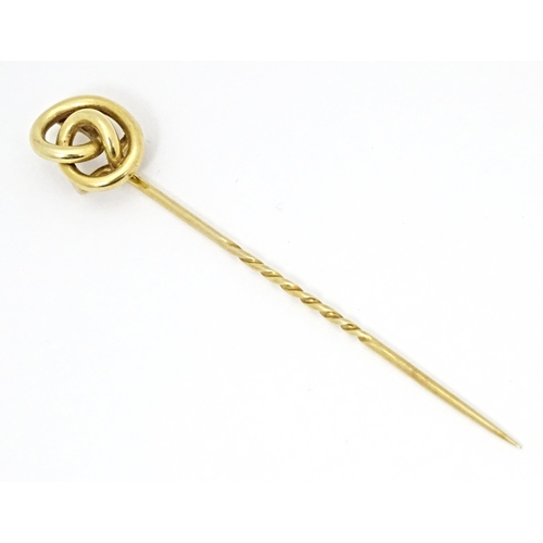 660 - A yellow metal stick pin with knot detail. Approx. 3