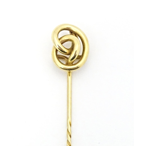 660 - A yellow metal stick pin with knot detail. Approx. 3