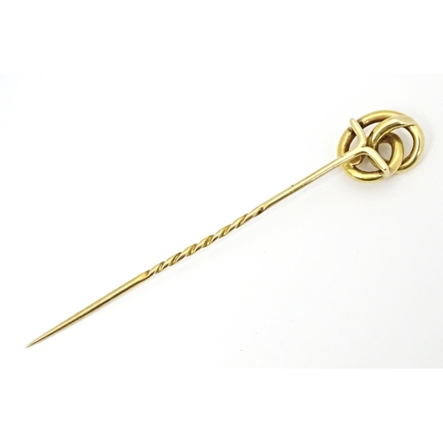 660 - A yellow metal stick pin with knot detail. Approx. 3