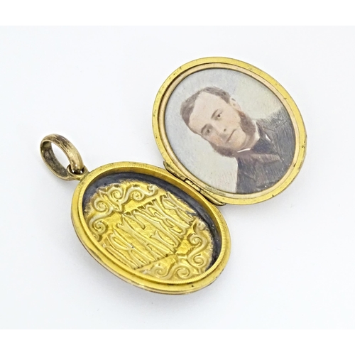 662 - A gilt metal oval locket of pendant form titled 'Regard' opening to reveal hand painted miniature wi... 