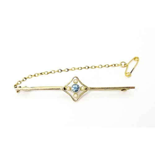 664 - A 9ct gold bar brooch set with aquamarine and seed pearl. Approx. 2 1/4