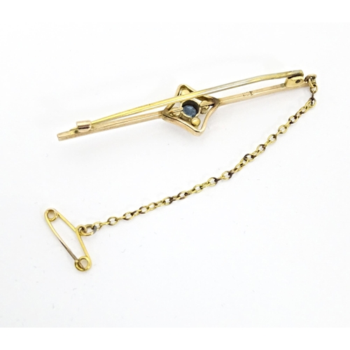 664 - A 9ct gold bar brooch set with aquamarine and seed pearl. Approx. 2 1/4