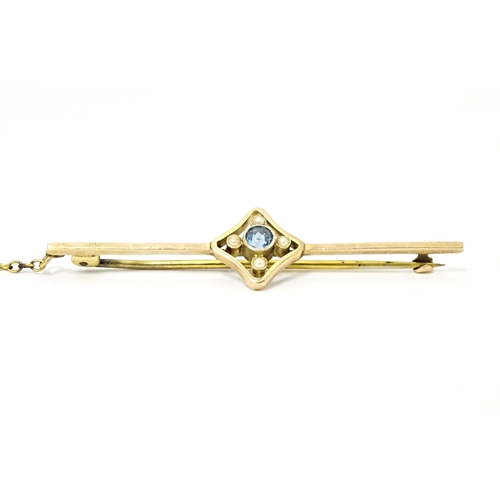 664 - A 9ct gold bar brooch set with aquamarine and seed pearl. Approx. 2 1/4