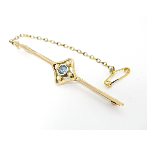 664 - A 9ct gold bar brooch set with aquamarine and seed pearl. Approx. 2 1/4