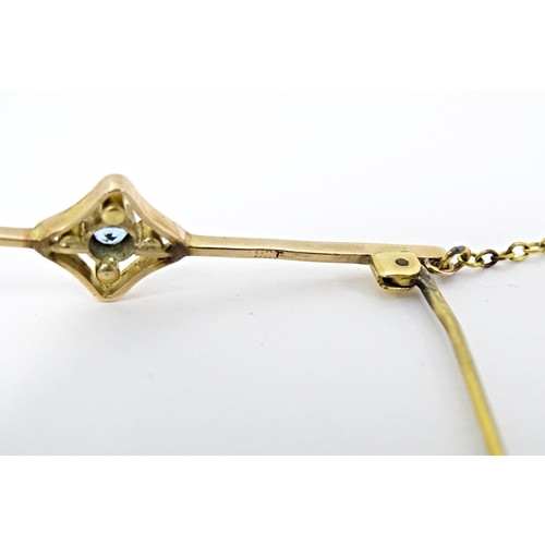 664 - A 9ct gold bar brooch set with aquamarine and seed pearl. Approx. 2 1/4