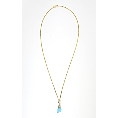 665 - A 9ct gold necklace with turquoise drop pendant. Chain approx. 20