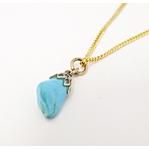 665 - A 9ct gold necklace with turquoise drop pendant. Chain approx. 20