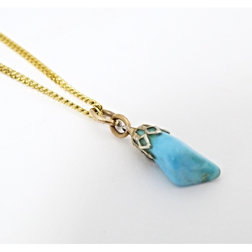 665 - A 9ct gold necklace with turquoise drop pendant. Chain approx. 20