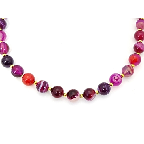 666 - A pink faux agate bead necklace. Approx. 18