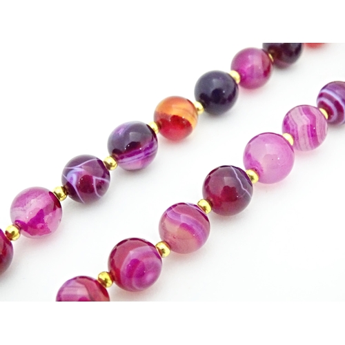 666 - A pink faux agate bead necklace. Approx. 18