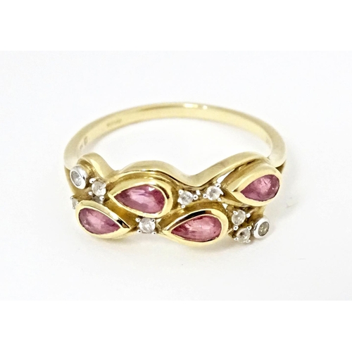 571 - A 9ct gold ring set with Padparadscha sapphire and white zircons. Ring size approx. R