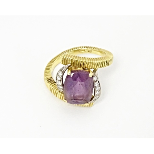 579 - An 18ct gold cocktail ring set with central amethyst flanked by diamonds. Ring size approx. O