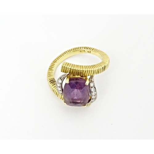 579 - An 18ct gold cocktail ring set with central amethyst flanked by diamonds. Ring size approx. O