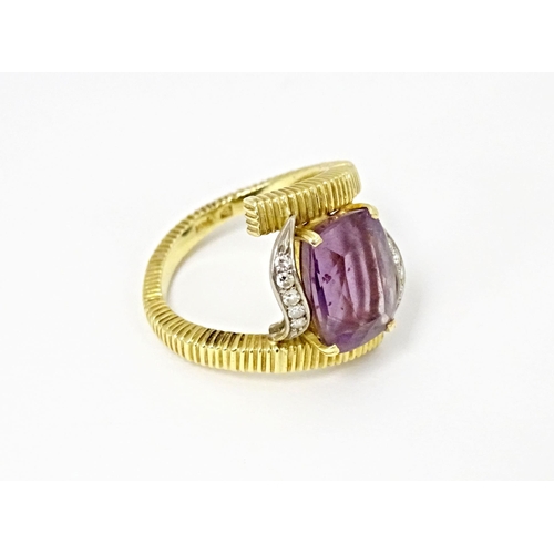 579 - An 18ct gold cocktail ring set with central amethyst flanked by diamonds. Ring size approx. O