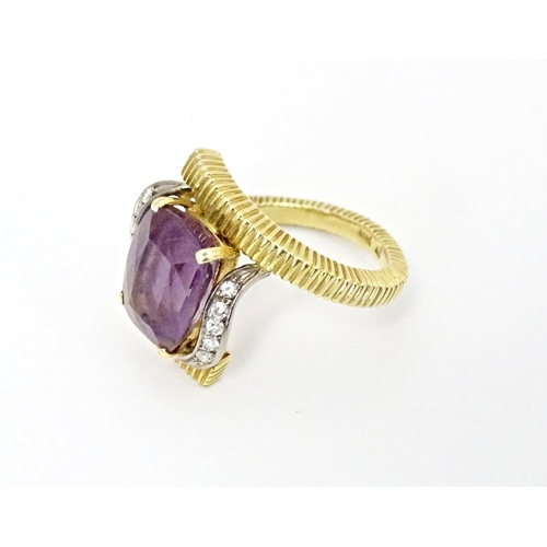 579 - An 18ct gold cocktail ring set with central amethyst flanked by diamonds. Ring size approx. O