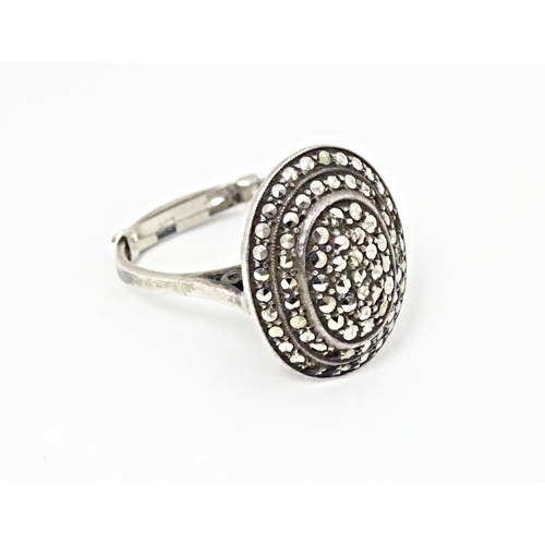 580 - A white metal ring set with a profusion of marcasite in an Art Deco setting. Ring size approx. Q