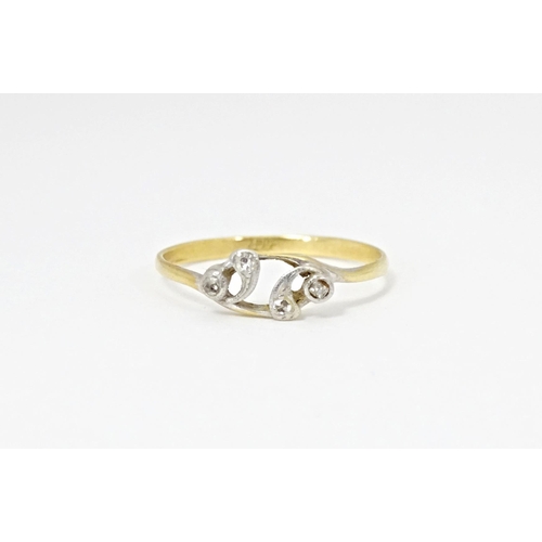 583 - An 18ct gold ring set with four diamonds. Ring size approx. N