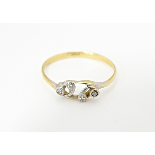 583 - An 18ct gold ring set with four diamonds. Ring size approx. N