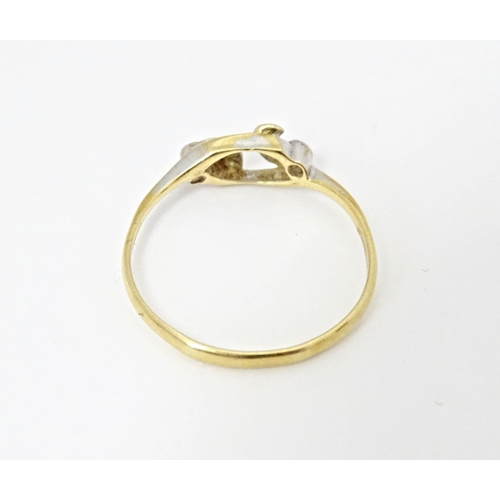 583 - An 18ct gold ring set with four diamonds. Ring size approx. N