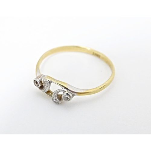 583 - An 18ct gold ring set with four diamonds. Ring size approx. N