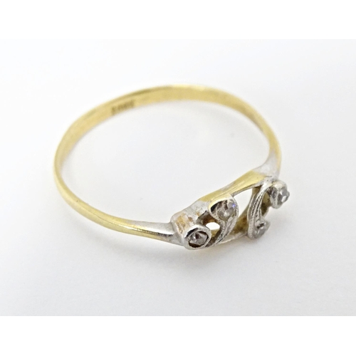 583 - An 18ct gold ring set with four diamonds. Ring size approx. N