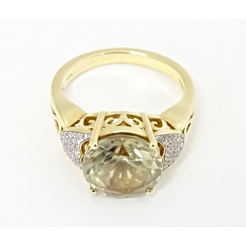 586 - An 18ct gold ring set with central Csarite flanked by diamonds. Ring size approx. N