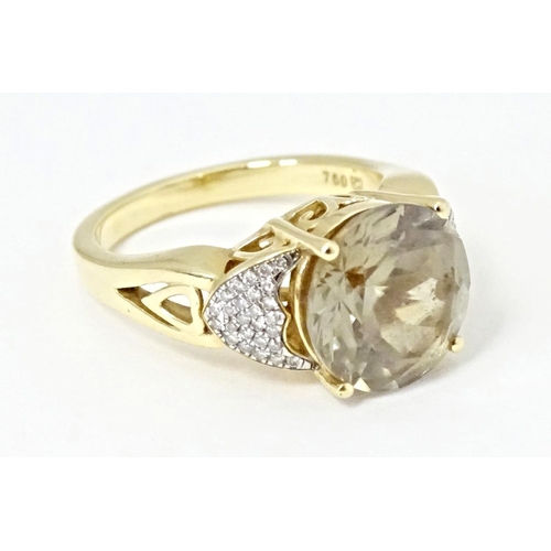 586 - An 18ct gold ring set with central Csarite flanked by diamonds. Ring size approx. N