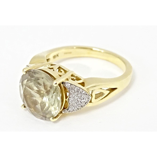 586 - An 18ct gold ring set with central Csarite flanked by diamonds. Ring size approx. N